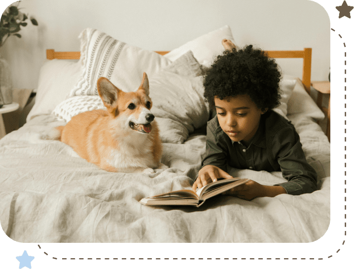 A boy and his dog are laying on the bed