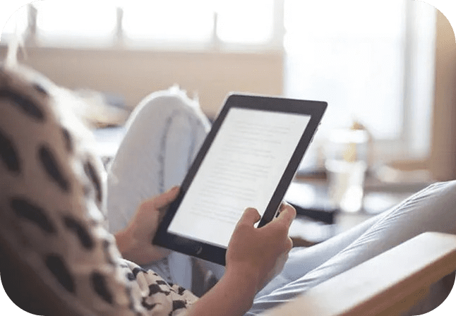 A person is holding an ipad in their hands.